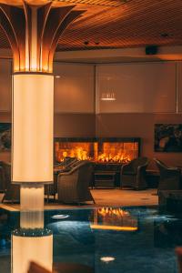 a lobby with a fireplace and a swimming pool at Hotel Kakola in Turku