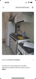 a kitchen with a white refrigerator and a stove at Apartamento do Sossego in São Luís