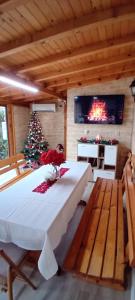 a dining room with a table and a christmas tree at Guest House Vasilena Самостоятелно наемане FREE PARKING in Sapareva Banya