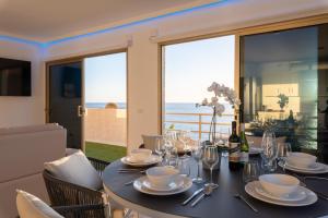 a dining room with a table with a view of the ocean at OBSIDIAN Mirador del Oceano in Puerto de Santiago