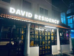 a building with a sign that reads paid residency at David Residency in Madurai