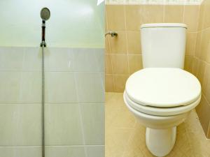 a bathroom with a toilet and a shower at SPOT ON 92875 Pelita Stay in Nagoya