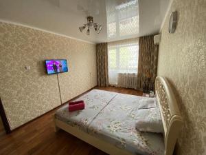 a bedroom with a bed in a room at 1 комн квартира в 6 мкр (Кунаева) in Uralsk