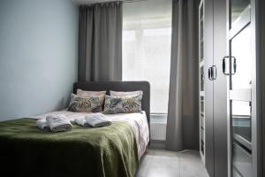 a bedroom with a bed with two towels on it at Apartament na Kaszubach in Kościerzyna