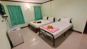 Dos camas en una habitación con dos ositos de peluche. en Lee-view Wangnamkeaw, en Wang Nam Khiao