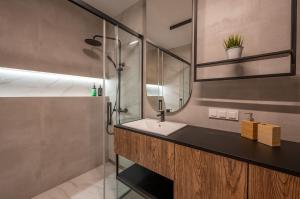 a bathroom with a sink and a shower at Solaris 711, sea view. in Darłowo