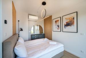 a bedroom with a bed and a mirror at Solaris 711, sea view. in Darłowo