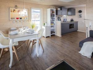 a kitchen and dining room with a table and chairs at Houseboat gray seal in Heiligenhafen