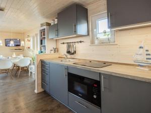 a kitchen with a sink and a counter top at Houseboat gray seal in Heiligenhafen