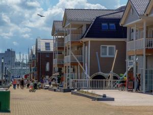 a group of houses on a street with people walking at Houseboat Seahorse in Heiligenhafen