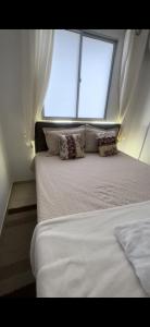 uma cama grande num quarto com uma janela em Apartamento do Sossego em São Luís