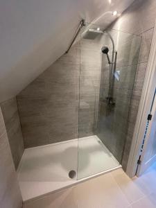 a shower with a glass door in a bathroom at Lakeview Barn, sleeps 5-7 Guests new inside in Matlock