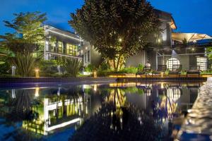 a house with a swimming pool at night at Gigiri Lion Villas in Nairobi