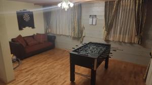 a living room with a table in the middle of it at Grand chalet au centre in Anzère