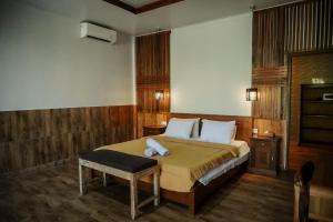a bedroom with a bed and a stool in it at De Olas Padang Padang Bali in Uluwatu +56 photos