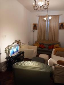 a living room with a couch and a tv at Rochester Corner in Rochester