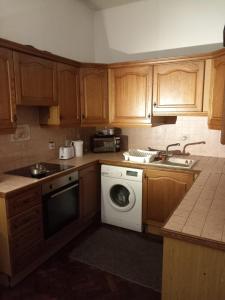 a kitchen with wooden cabinets and a washing machine at Rochester Corner in Rochester