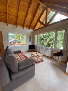 a living room with a couch and a table at Andalue in San Carlos de Bariloche +105 photos