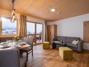 a living room with a table and a couch at M&M Appartements Brixental in Westendorf