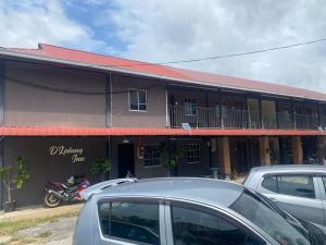 a building with a motorcycle parked in front of it at OYO 90910 Homestay D Lalang Inn in Kuah