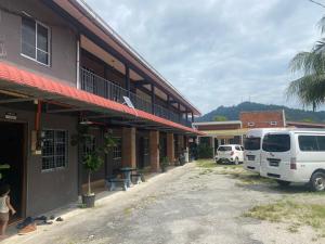 a white van parked in front of a building at OYO 90910 Homestay D Lalang Inn in Kuah