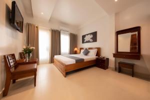 Postel nebo postele na pokoji v ubytování Ngọc Châu Hotel