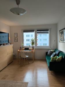 a living room with a couch and a table and a desk at Ferienwohnung für 1-3 Personen in BERLIN, Nähe U Friedrichsfelde in Berlin