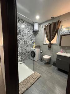 a bathroom with a shower and a toilet and a sink at Serenity Sea-view Maisonette in Marsalforn