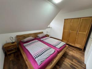 a bedroom with a large bed and wooden cabinets at Wanderlust in Ilsenburg
