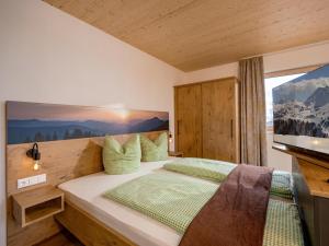 a bedroom with a large bed with a large window at M&M Appartements Brixental in Westendorf