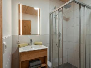 a bathroom with a sink and a shower at M&M Appartements Brixental in Westendorf