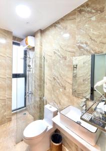 a bathroom with a toilet and a sink at TTR Midtown View Hotel in Da Lat