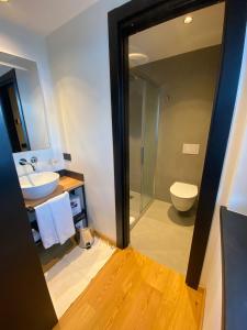 La salle de bains est pourvue d'un lavabo, de toilettes et d'un miroir. dans l'établissement Cronox Rin, à Livigno