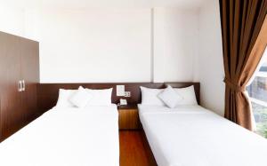 Postel nebo postele na pokoji v ubytování TTR Midtown View Hotel