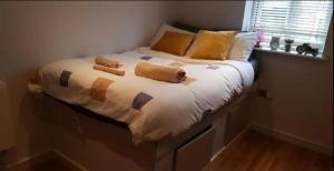a bed with two pillows on it in a bedroom at Affordable Flats - Derby City Centre in Derby