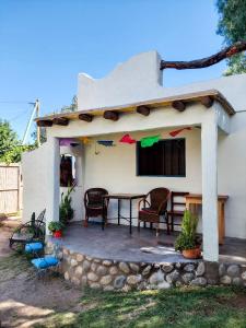 a porch of a house with a table and chairs at La Casa de Vero in Cachí