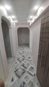 a hallway with a door and a tile floor at Engin HOME in Pamukkale