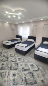 a bedroom with two beds and a rug at Engin HOME in Pamukkale