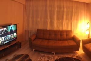 a living room with a couch and a television at Engin HOME in Pamukkale