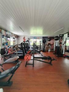 a gym with a lot of tread machines in it at Apartamento Clube 3/4 com Ar-condicionado in Aracaju