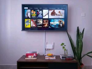 a flat screen tv hanging on a wall at Serene Palace in Nairobi