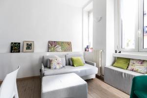 a living room with a couch and a chair at Rogoredo - Exclusive Apartment in Milan