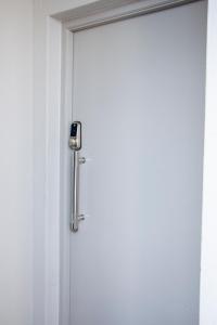 an open door with a silver door handle at Eden Suites in Sandton