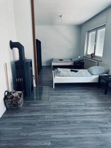 a room with a bed and a stove in it at StadtHOUSE Bentheim Viel Platz für Gruppen in Bad Bentheim