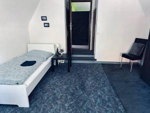 a bedroom with a bed and a table and a chair at StadtHOUSE Bentheim Viel Platz für Gruppen in Bad Bentheim +17 photos