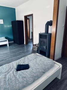 a bedroom with a bed and a stove at StadtHOUSE Bentheim Viel Platz für Gruppen in Bad Bentheim