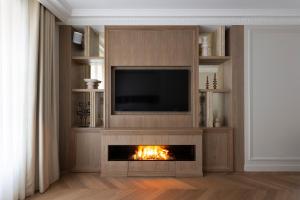 a living room with a fireplace and a tv at HIGHSTAY - Luxury Serviced Apartments - Centre Pompidou in Paris