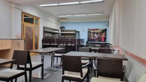 a dining room with tables and chairs in it at Hotel Rada in Ostrava