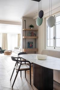 a kitchen and living room with a table and chairs at HIGHSTAY - Luxury Serviced Apartments - Centre Pompidou in Paris +53 photos