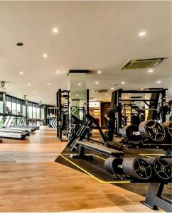 a gym with rows of treadmills and machines at Kamala poolview 2 bedroom suite in Kamala Beach